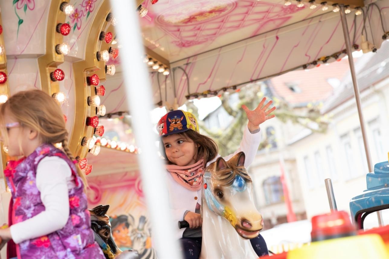 Child rides a merry-go-round